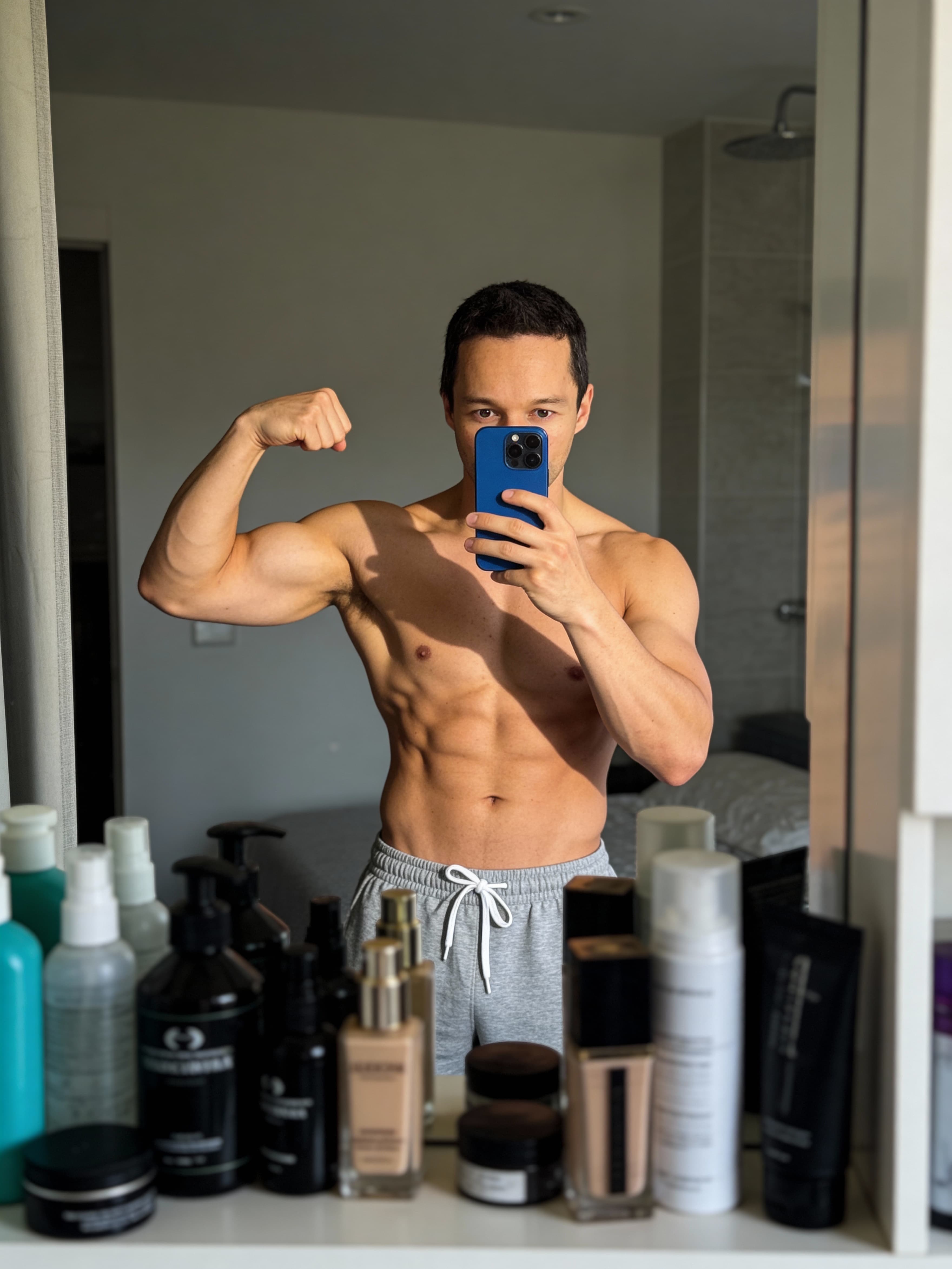 Example: fitness mirror selfie of a man in a bathroom