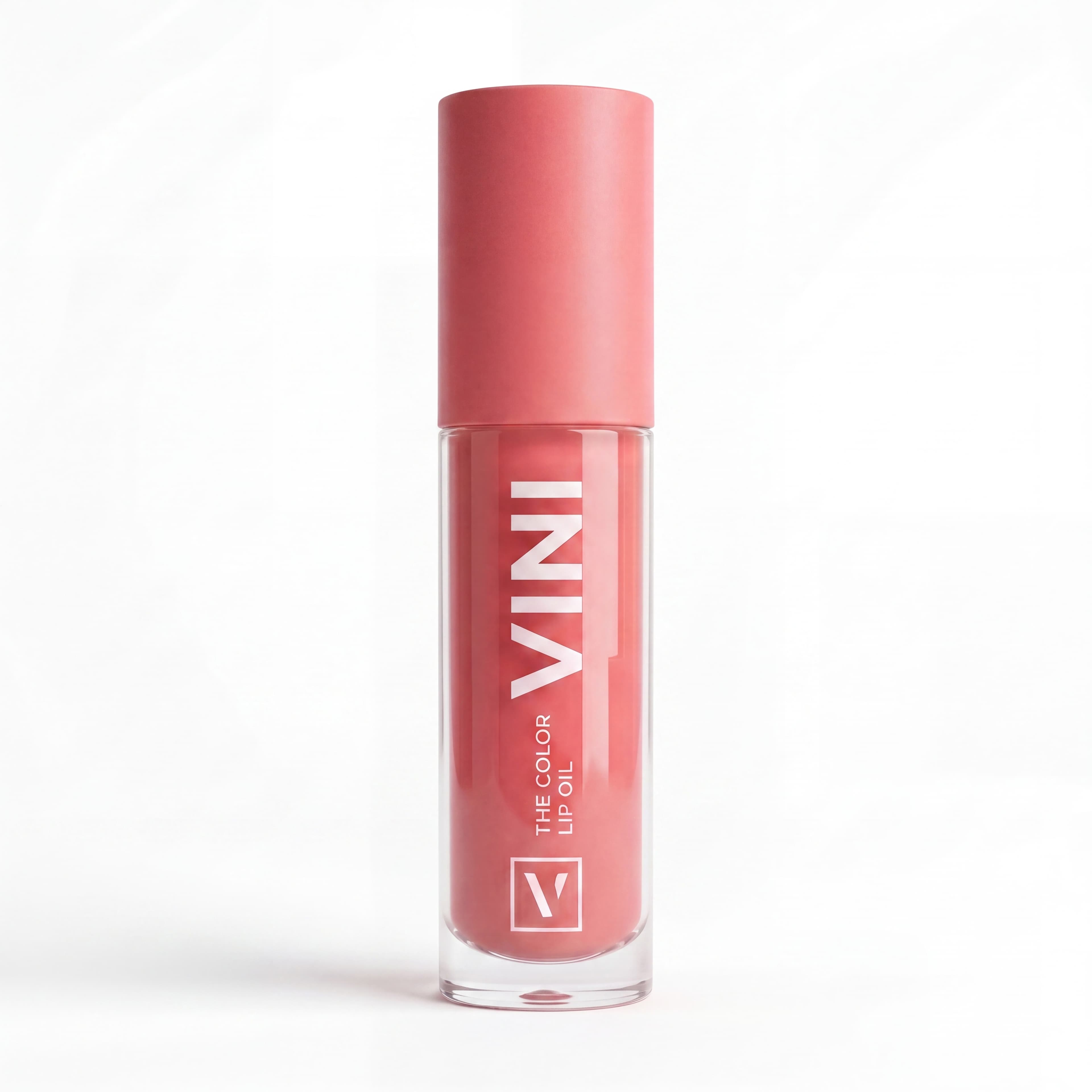 Tubo cerrado del lip oil en un entorno lifestyle sobre un mostrador de baño