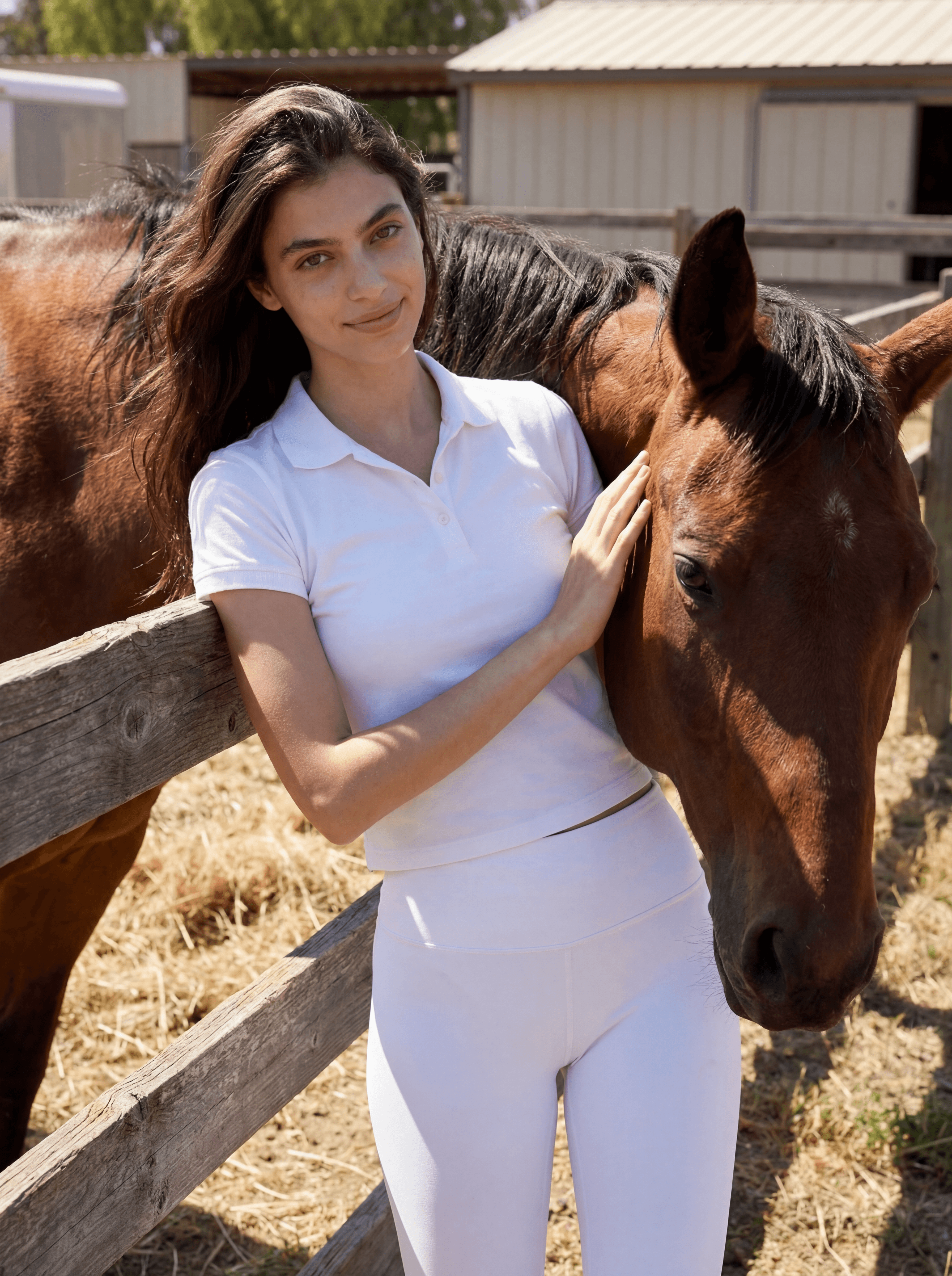 Example: woman posing beside a horse at a ranch