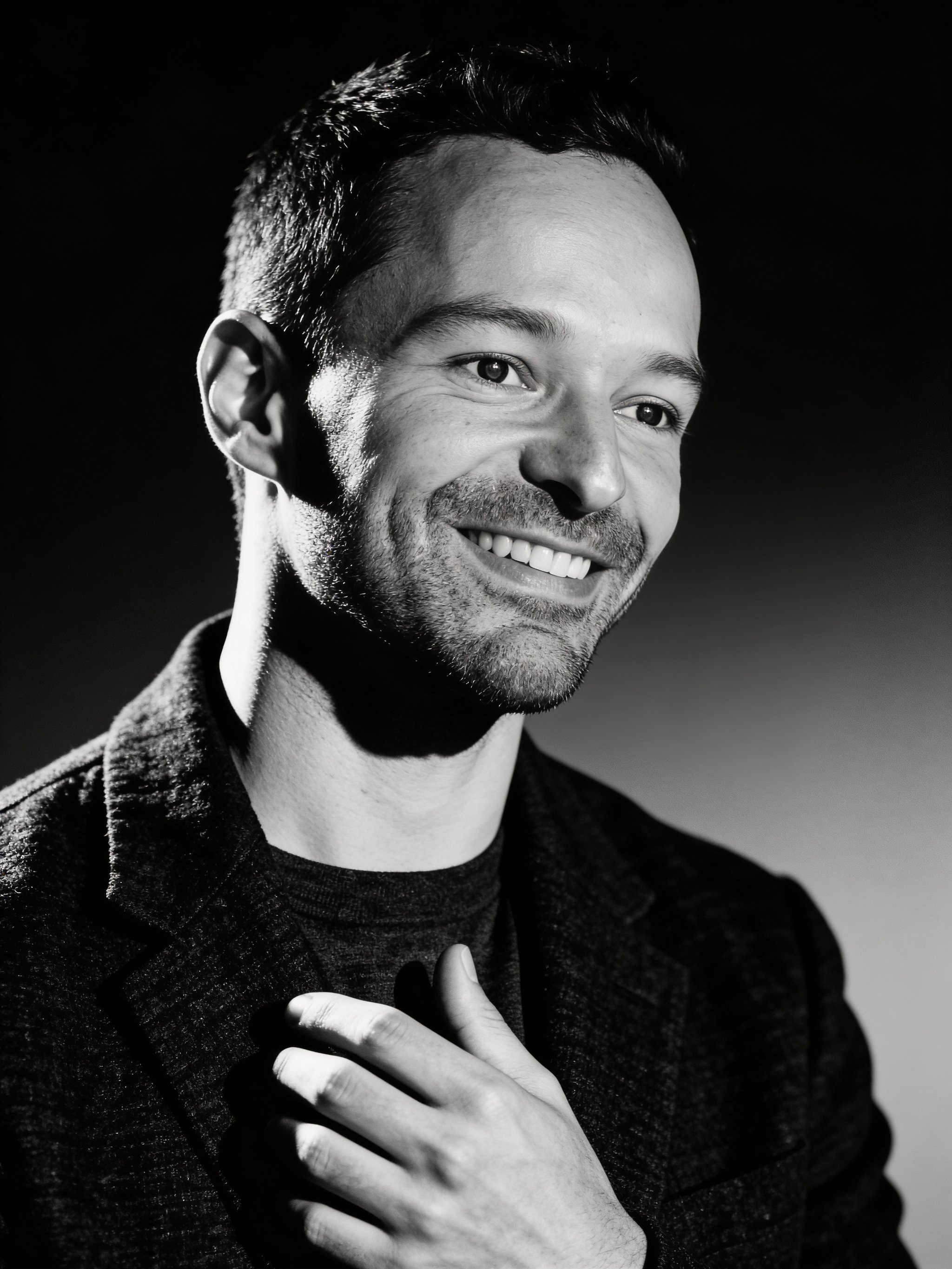 Dramatic studio headshot in black and white