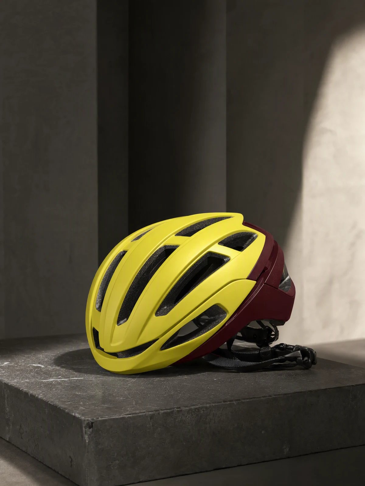 Acid-yellow cycling helmet on a basalt block, generated with GPT Image 2