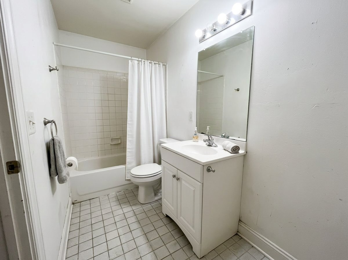 Bathroom listing photo after cleaner color balance, reduced glare, and more readable shadow detail