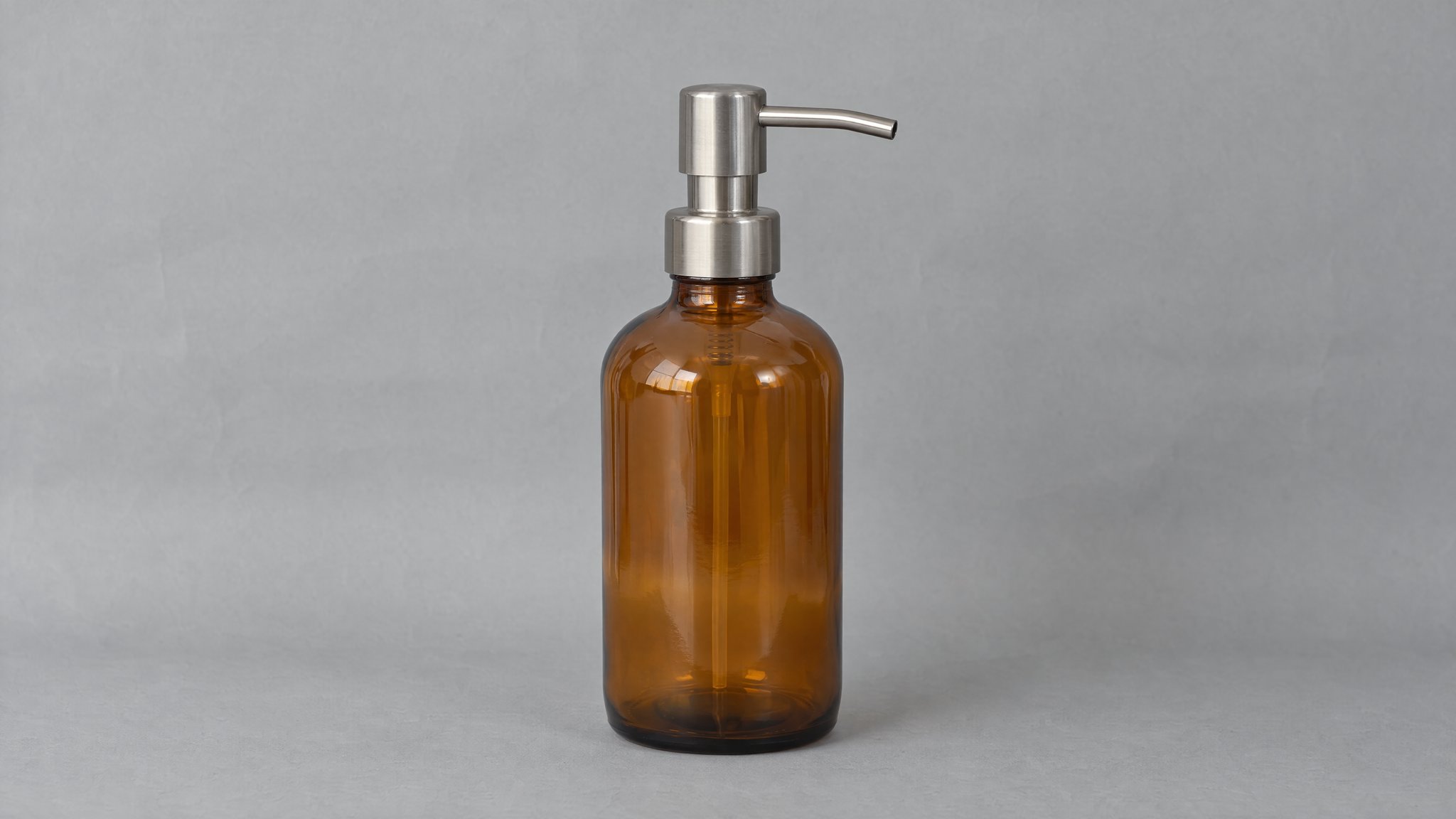 Amber glass soap dispenser with a steel pump on gray paper, generated with AI