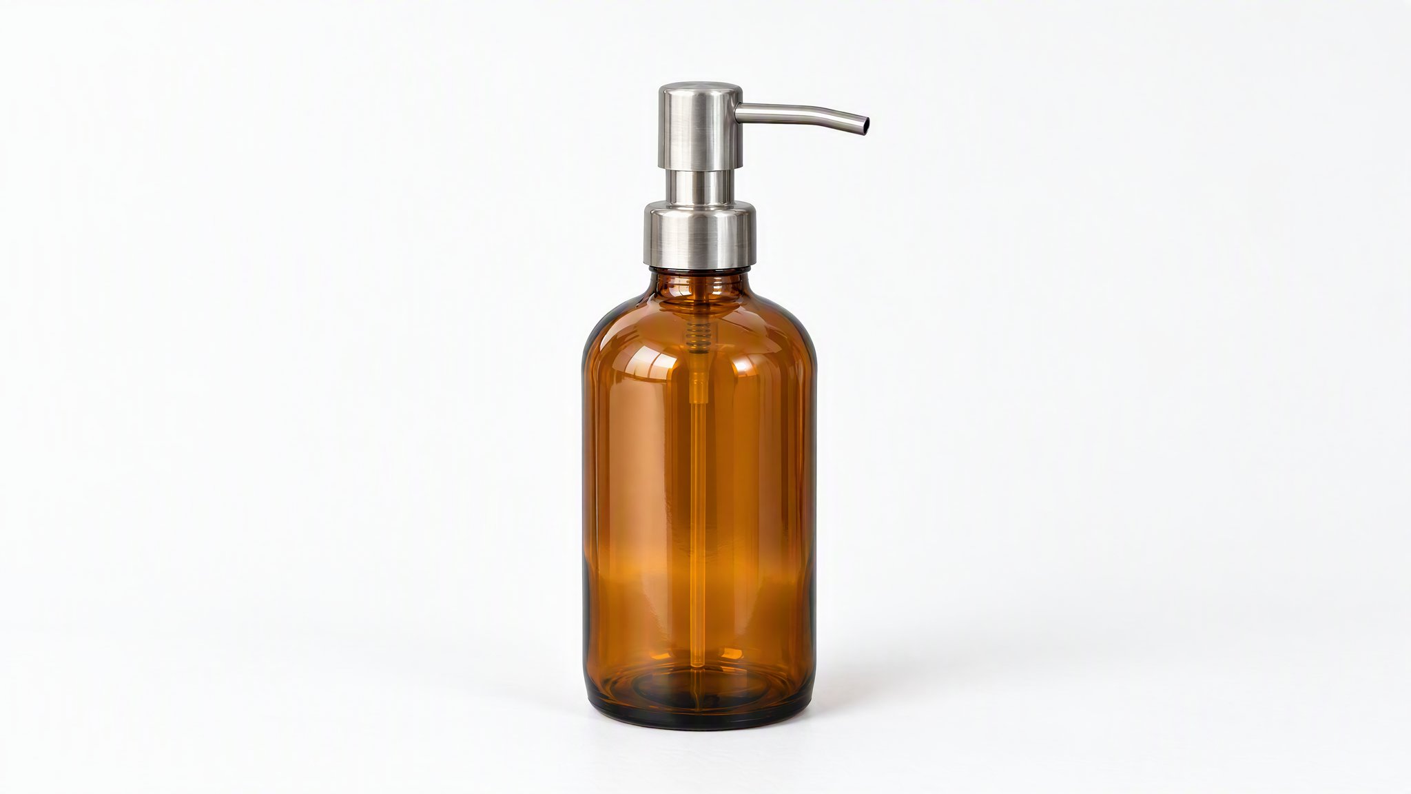 Amber glass soap dispenser with a steel pump on a white background