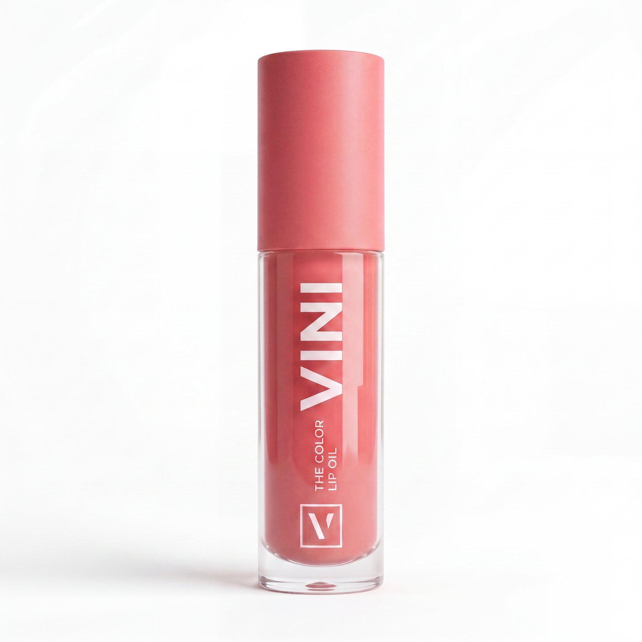 Tubo cerrado del lip oil en un entorno lifestyle sobre un mostrador de baño