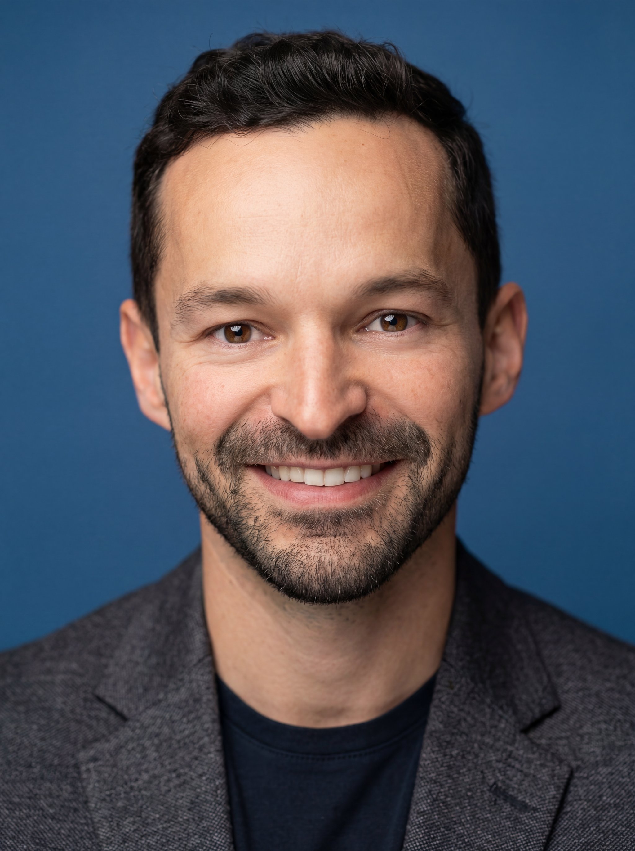 Example: professional studio profile photo with blue backdrop