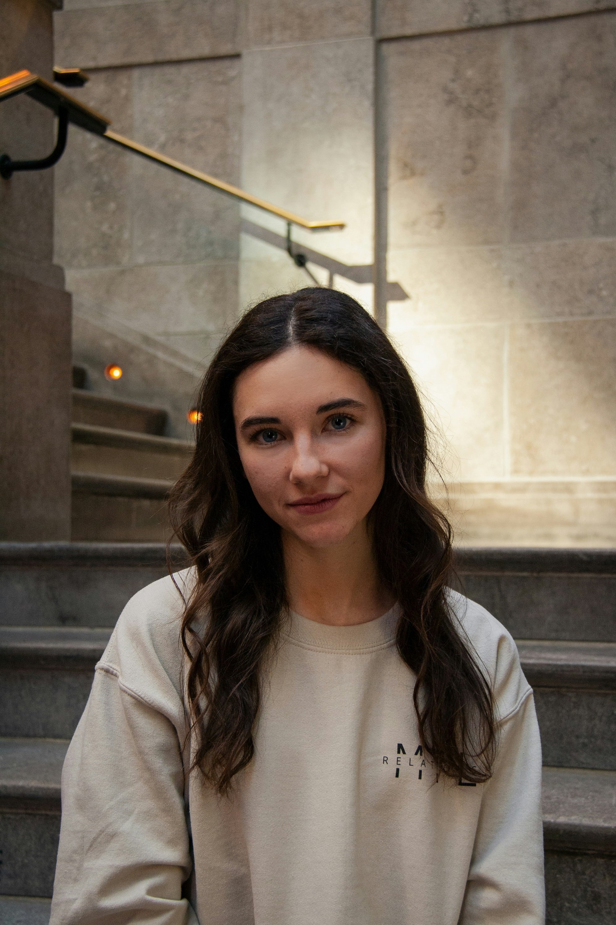 Original portrait on stone staircase used as input for the lighting transformation comparison