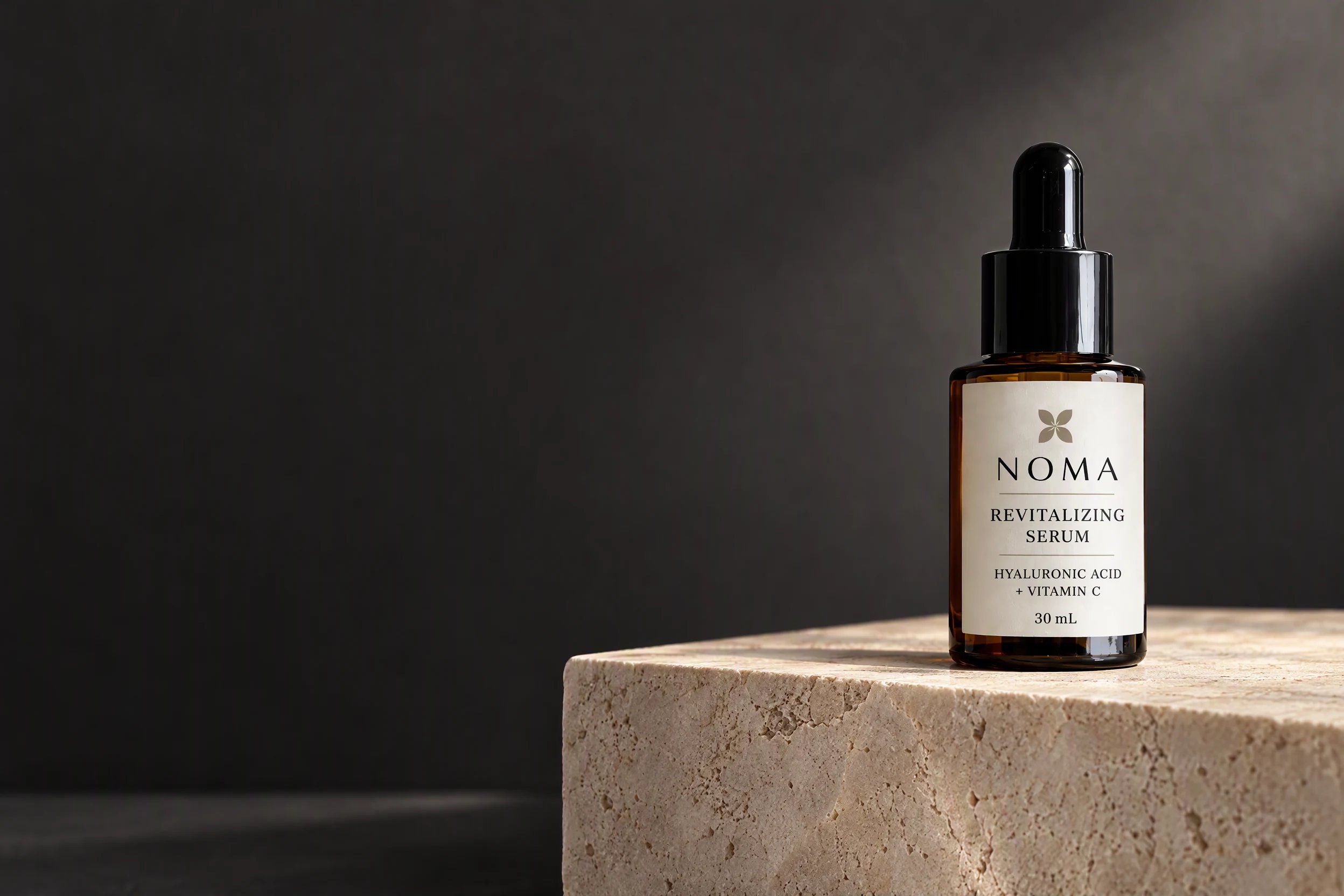 NOMA serum generated in HummingBytes as a campaign image on ivory stone against a charcoal background